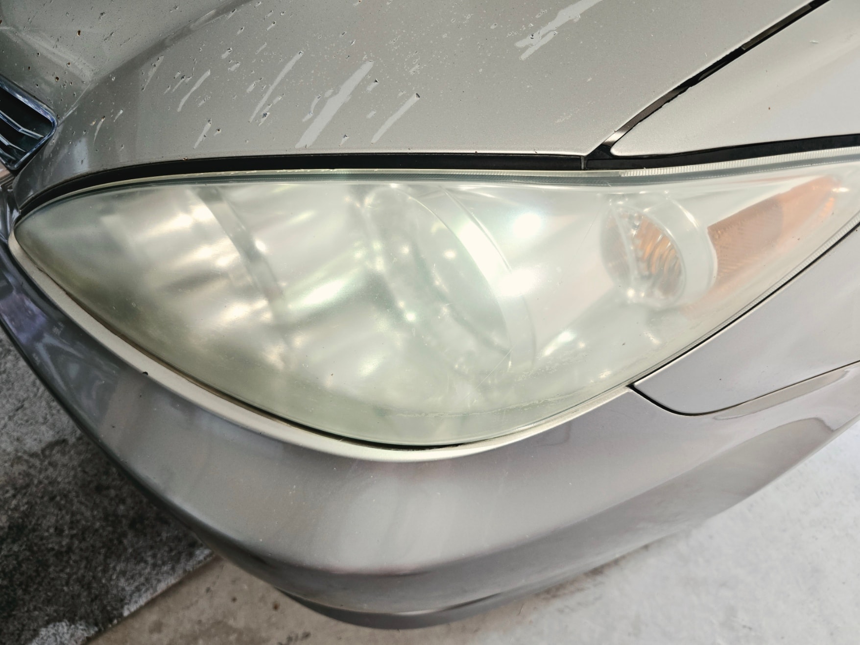 Yellowed driver side headlight before restoration